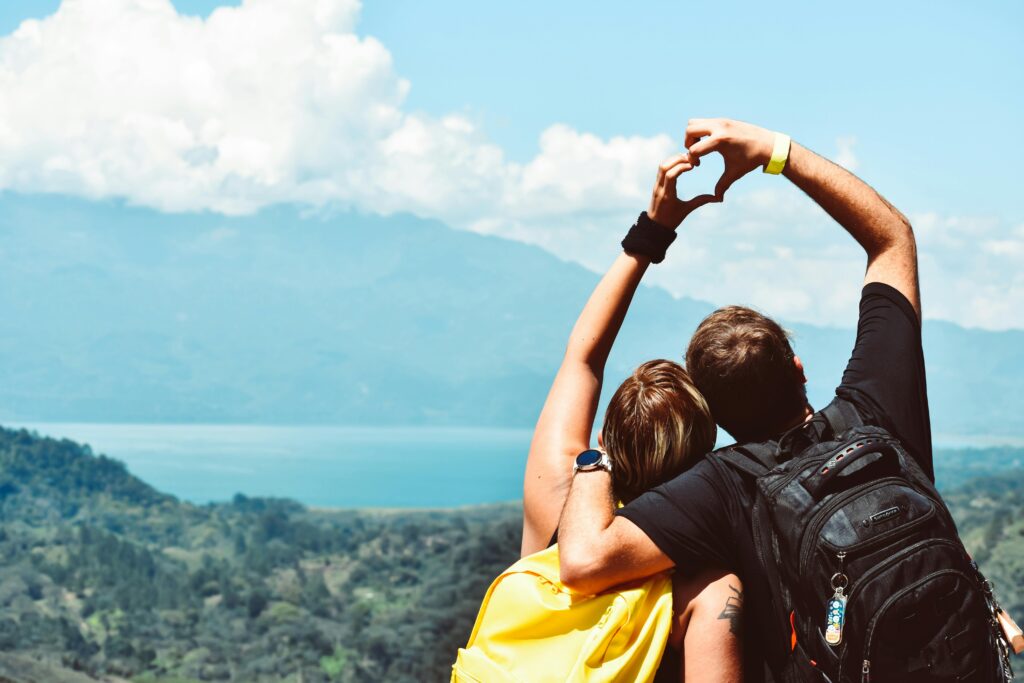 Two hikers standing at a mountain viewpoint with during an adventure travel experience
